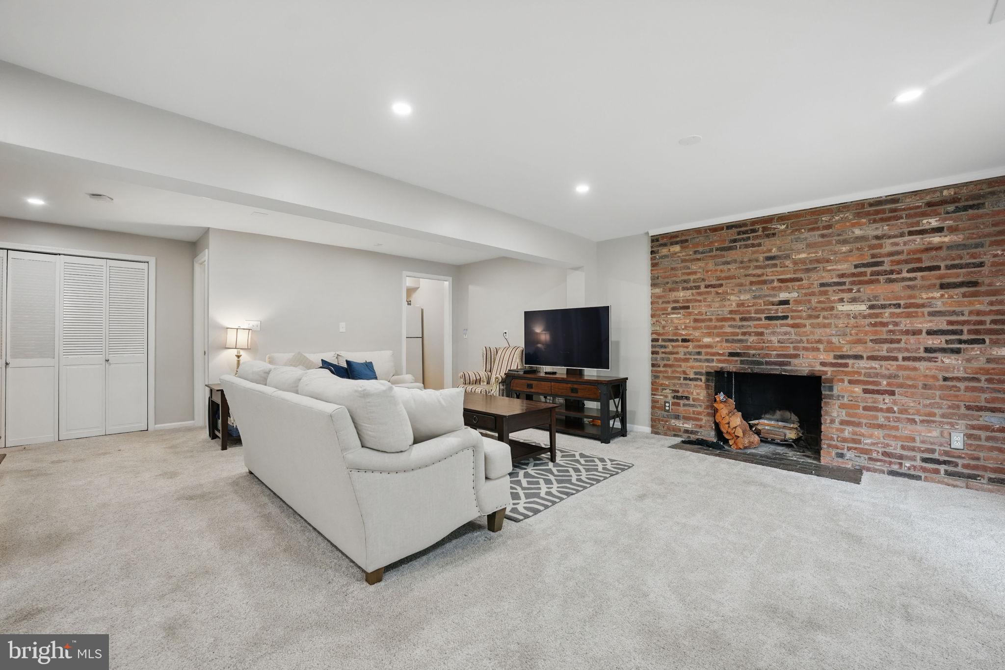 8333 Wickham Road Springfield, VA 22152 - Photo 41 of 54 a living room with furniture and a fireplace