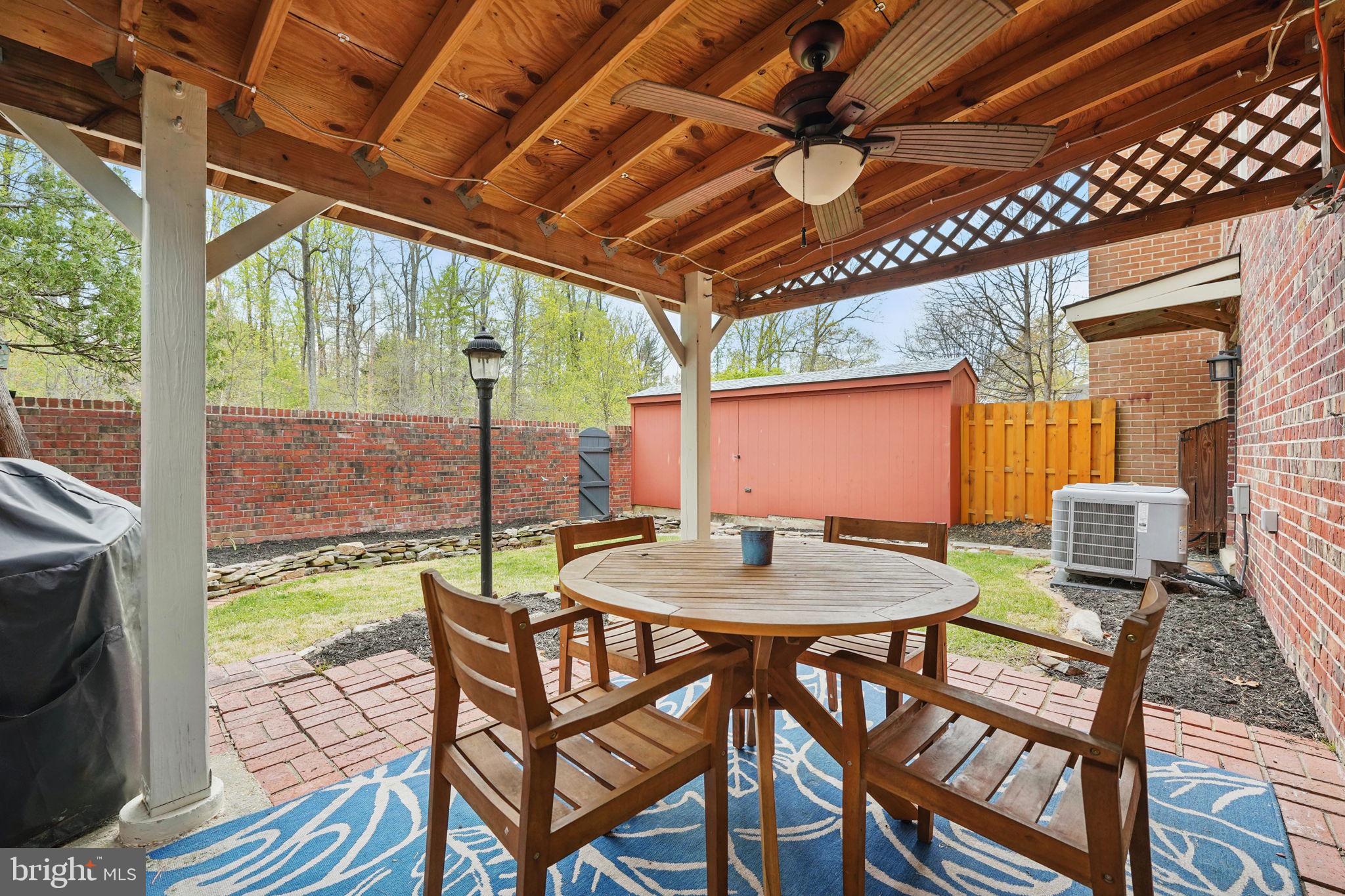 8333 Wickham Road Springfield, VA 22152 - Photo 45 of 54 a patio with yard glass top table and chairs
