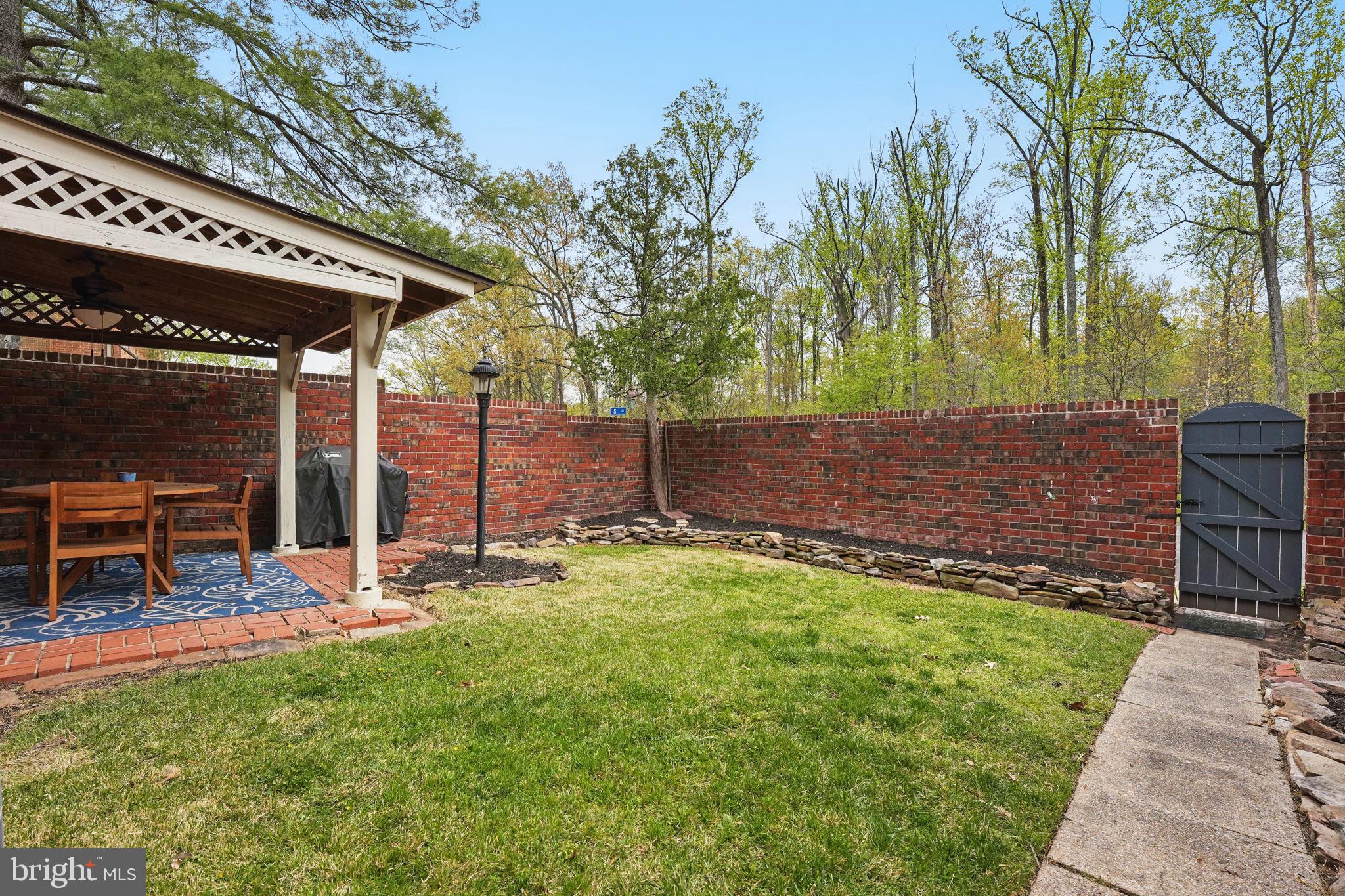 8333 Wickham Road Springfield, VA 22152 - Photo 46 of 54 a backyard of a house with table and chairs