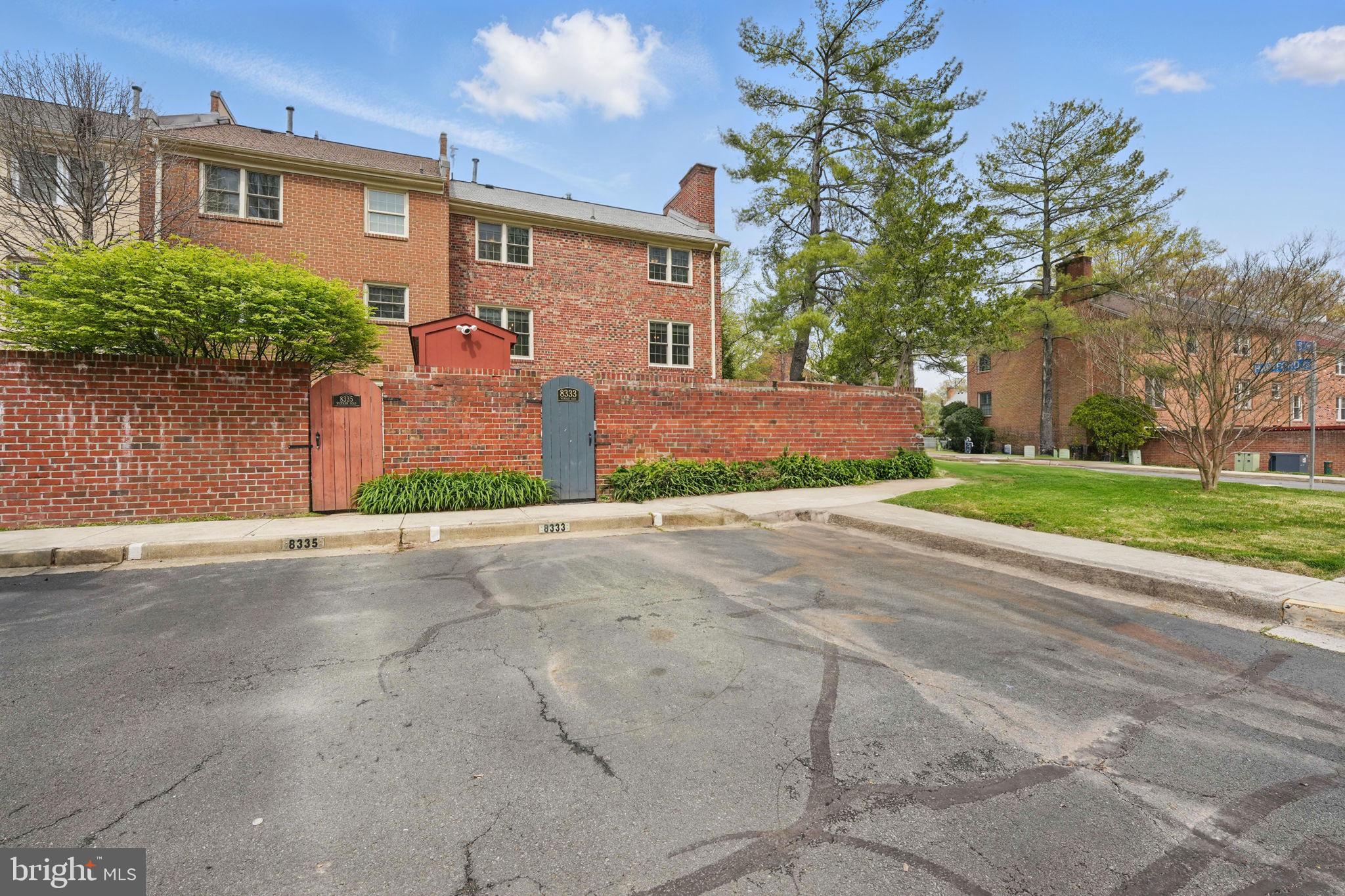 8333 Wickham Road Springfield, VA 22152 - Photo 48 of 54 a front view of a house with a yard and a garage