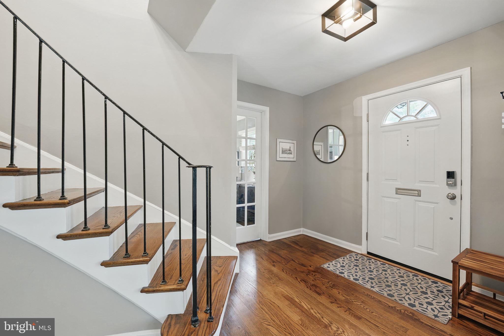 8333 Wickham Road Springfield, VA 22152 - Photo 5 of 54 a view of a hallway with wooden floor and staircase
