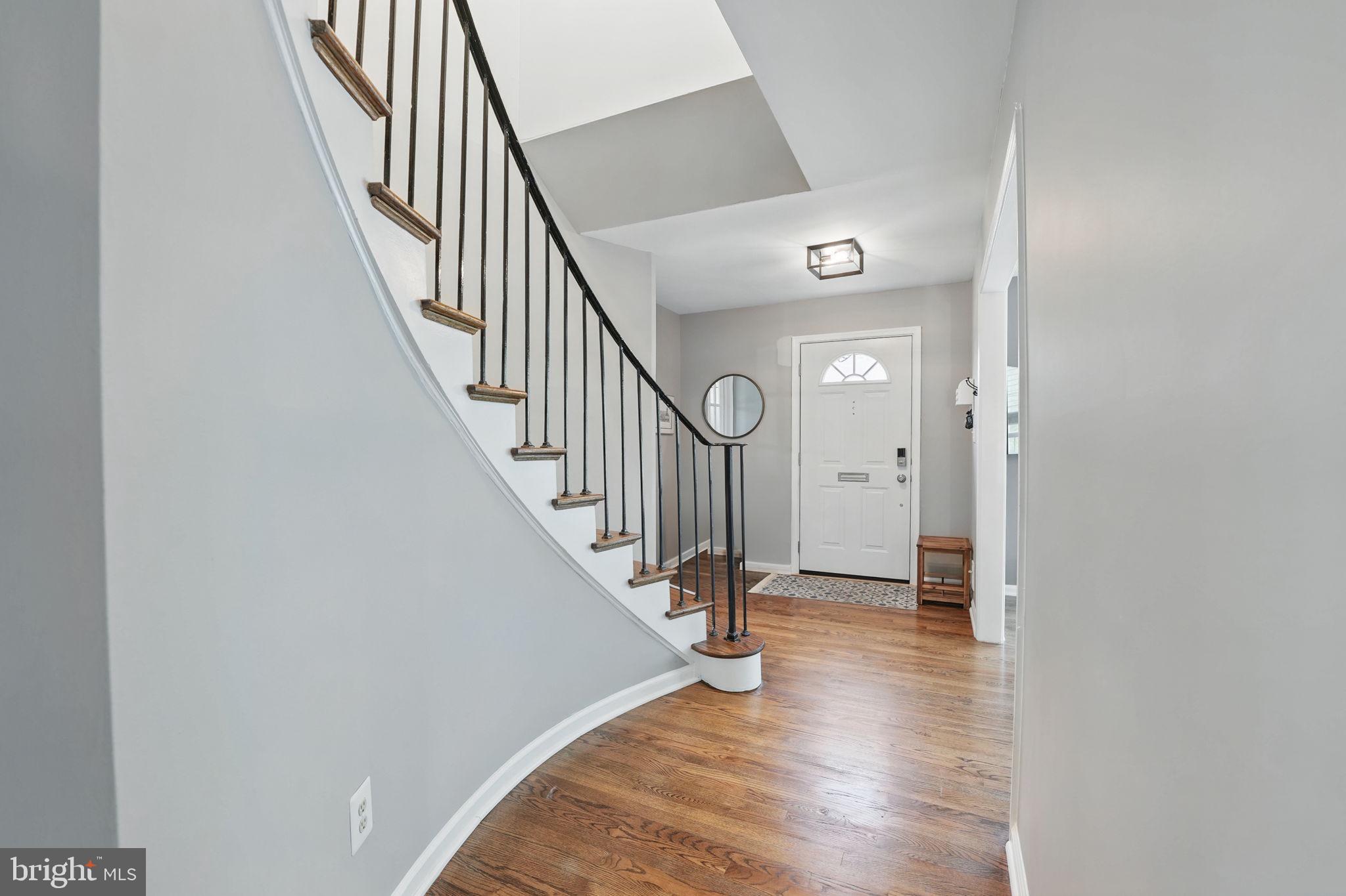 8333 Wickham Road Springfield, VA 22152 - Photo 6 of 54 a view of a hallway with wooden floor and staircase