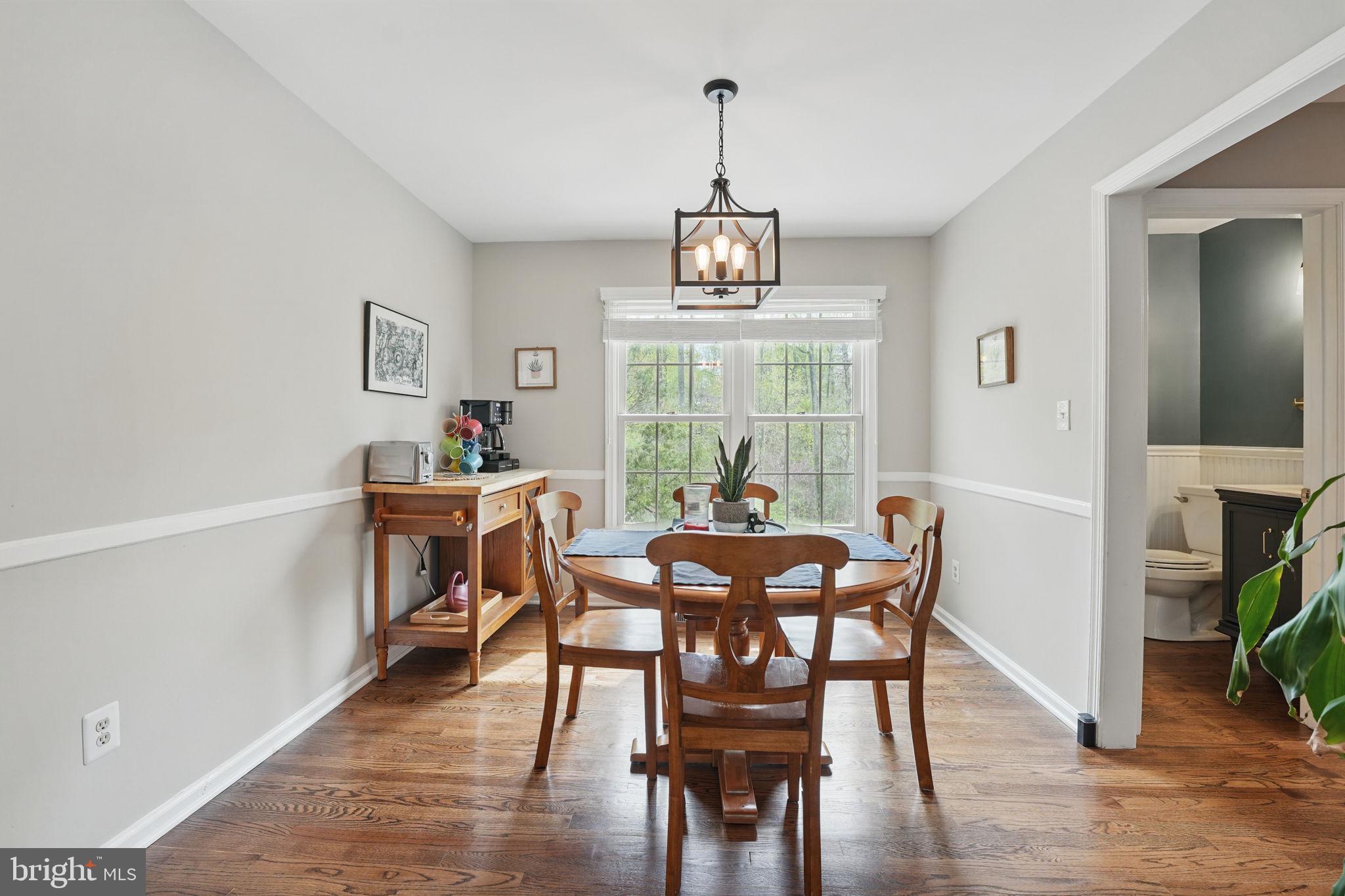 8333 Wickham Road Springfield, VA 22152 - Photo 10 of 54 a view of a dining room with furniture window and wooden floor