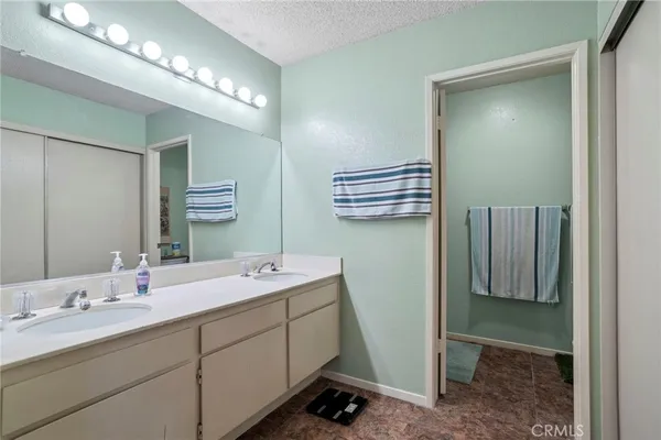 a bathroom with a double vanity sink and mirror