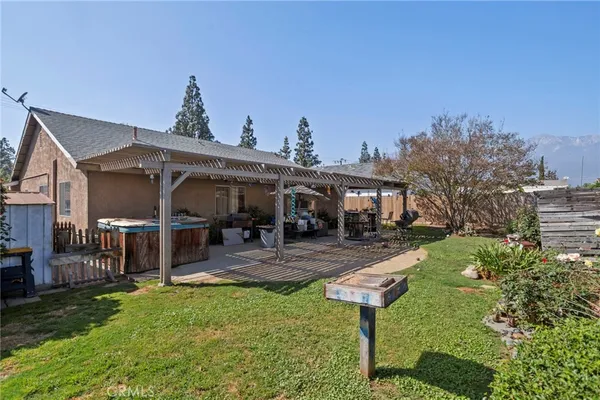 a view of a house with backyard porch and sitting area