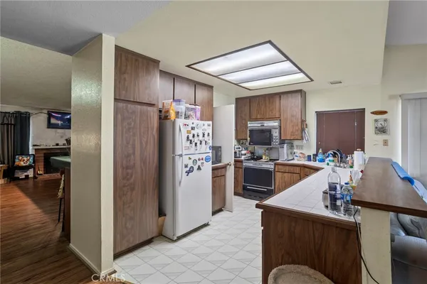 a kitchen with kitchen island a refrigerator stove and microwave