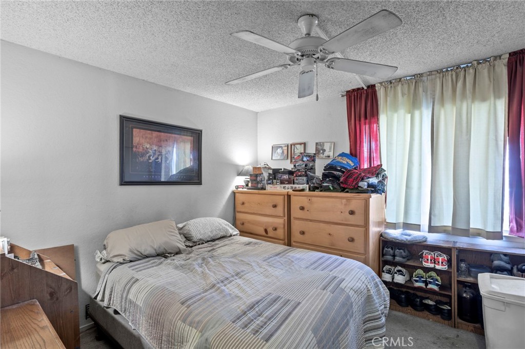 7823 Ramona Avenue Rancho Cucamonga, CA 91730 - Photo 10 of 18 a bedroom with a bed and wooden floor