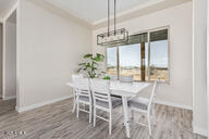 23109 West Skinner Road Wittmann, AZ 85361 - Photo 16 of 39 a dining room with furniture window and wooden floor