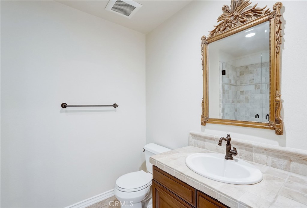 7 Tuscany Ladera Ranch, CA 92694 - Photo 16 of 39 a bathroom with a sink toilet and mirror