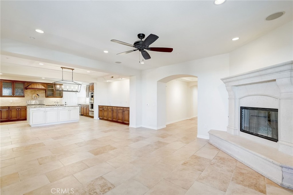 7 Tuscany Ladera Ranch, CA 92694 - Photo 7 of 39 a view of a livingroom with a fireplace cabinets and a ceiling fan