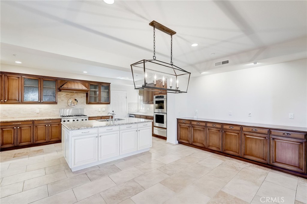 7 Tuscany Ladera Ranch, CA 92694 - Photo 8 of 39 a kitchen with stainless steel appliances granite countertop a stove oven and a sink