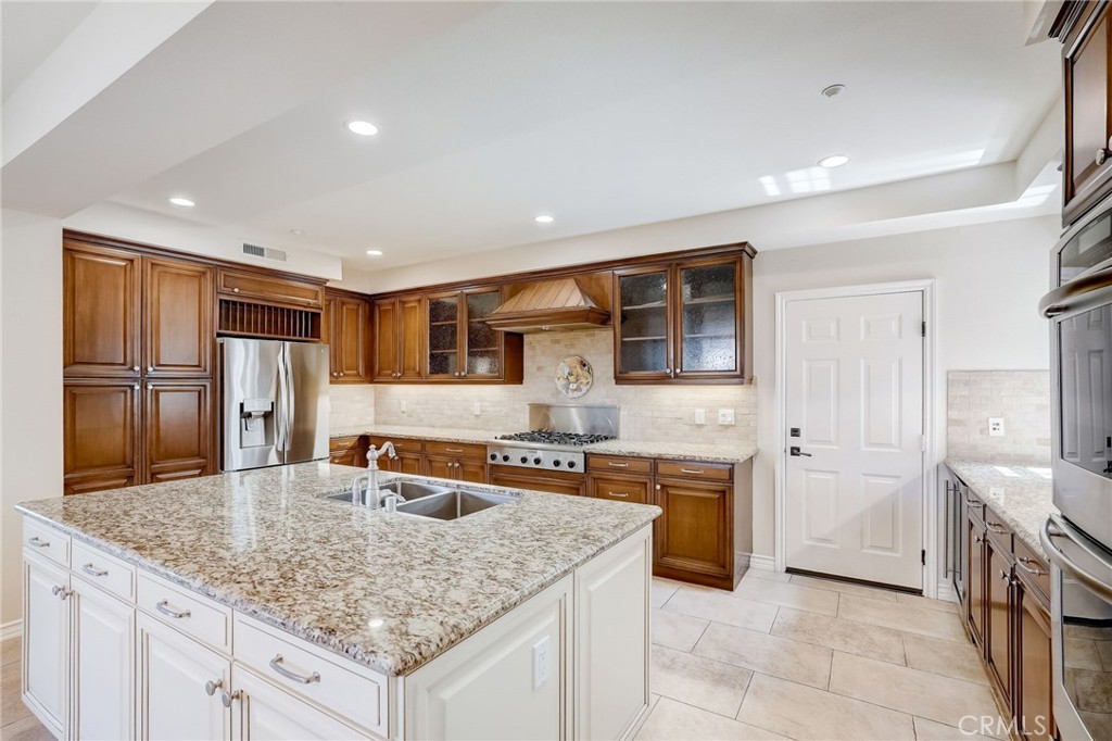 7 Tuscany Ladera Ranch, CA 92694 - Photo 9 of 39 a kitchen with stainless steel appliances granite countertop a sink and cabinets