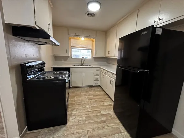 a kitchen with a sink stainless steel appliances and cabinets