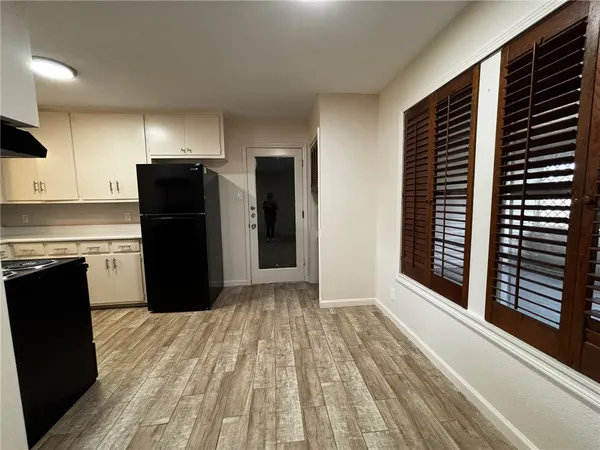 a kitchen with a refrigerator and a stove