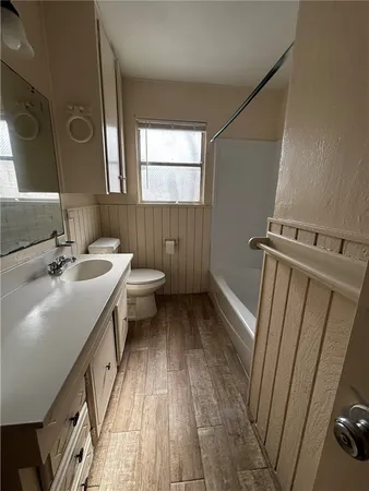 a bathroom with sink a toilet and a mirror