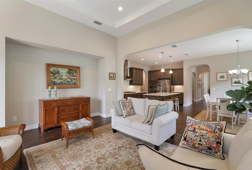 2402 Starwood Court Lakewood Ranch, FL 34211 - Photo 22 of 71 a living room with furniture and a dining table with kitchen view