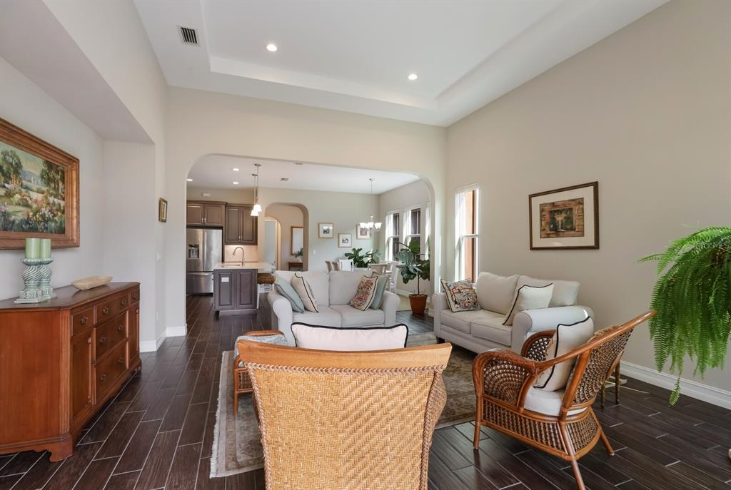 2402 Starwood Court Lakewood Ranch, FL 34211 - Photo 23 of 71 a living room with furniture and a dining room