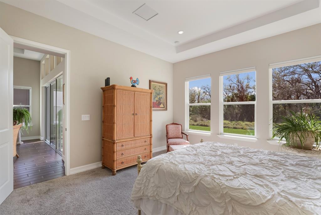 2402 Starwood Court Lakewood Ranch, FL 34211 - Photo 27 of 71 a spacious bedroom with a bed and a large window