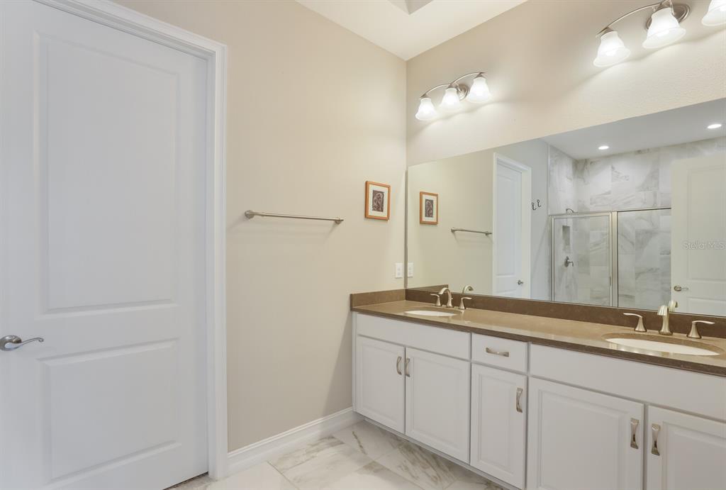 2402 Starwood Court Lakewood Ranch, FL 34211 - Photo 28 of 71 a bathroom with a sink and a mirror