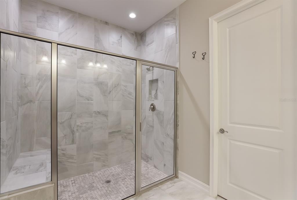 2402 Starwood Court Lakewood Ranch, FL 34211 - Photo 29 of 71 a bathroom with a glass shower door