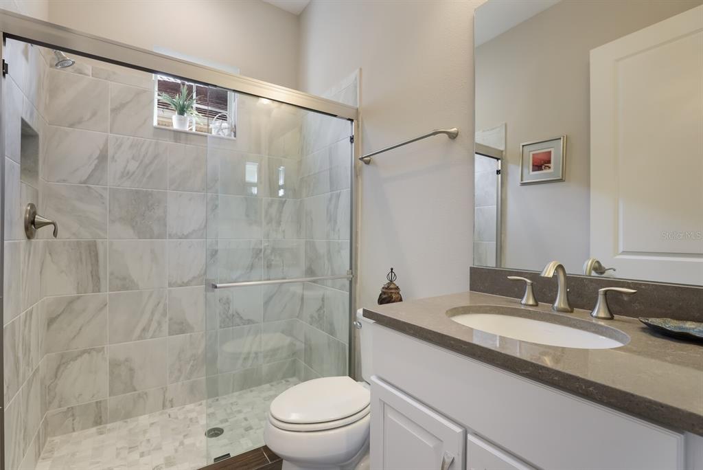 2402 Starwood Court Lakewood Ranch, FL 34211 - Photo 33 of 71 a bathroom with a granite countertop sink toilet and shower