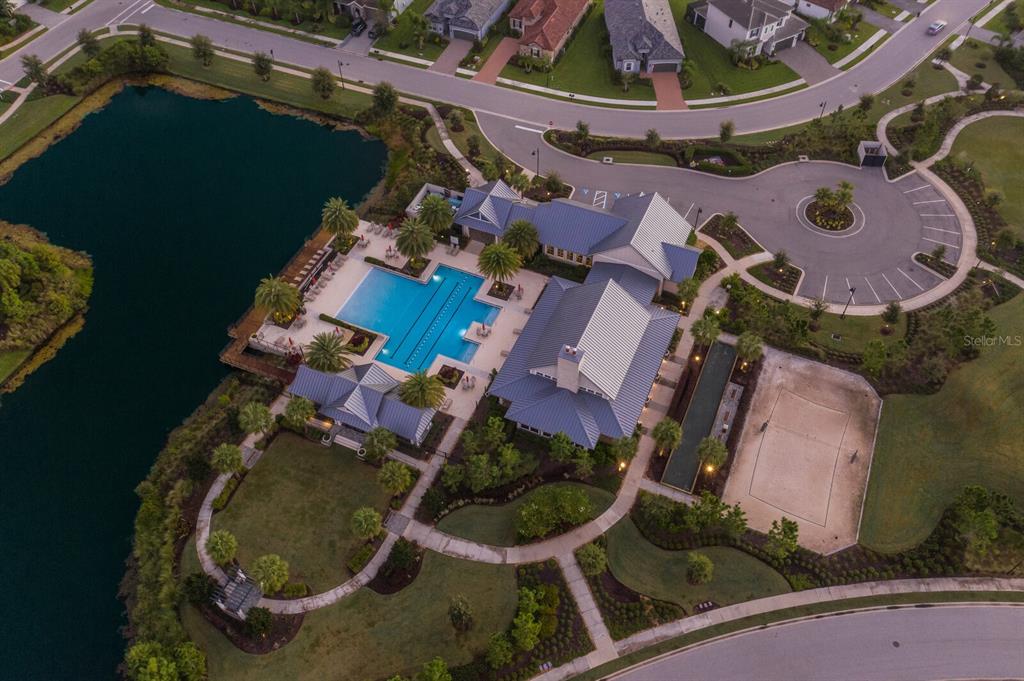 2402 Starwood Court Lakewood Ranch, FL 34211 - Photo 53 of 71 an aerial view of a house with garden space and a swimming pool