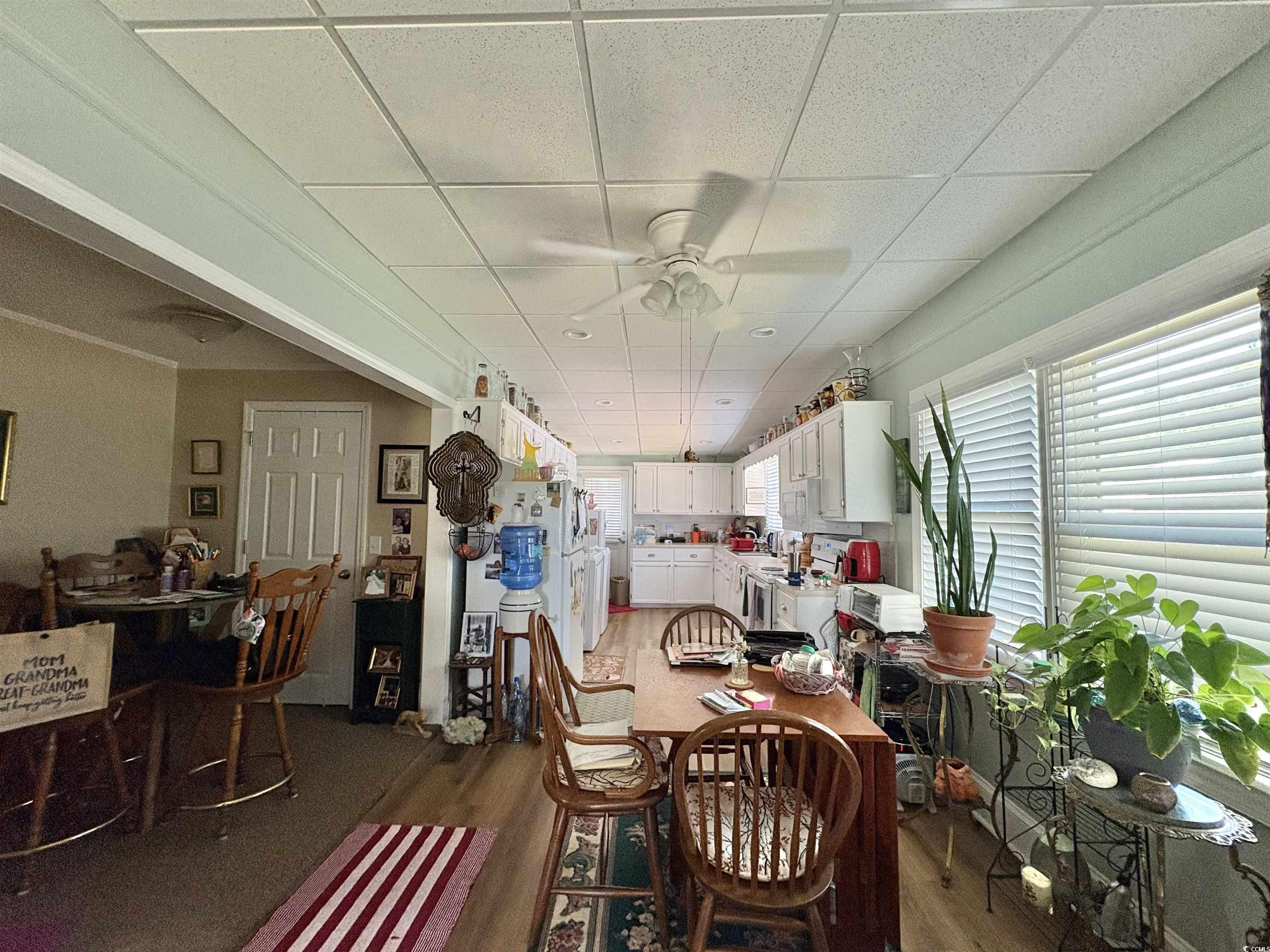 520-526 Boundary Avenue Murrells Inlet, SC 29576 - Photo 14 of 38 Dining room with dark wood-style floors, a ceiling fan, and a paneled ceiling
