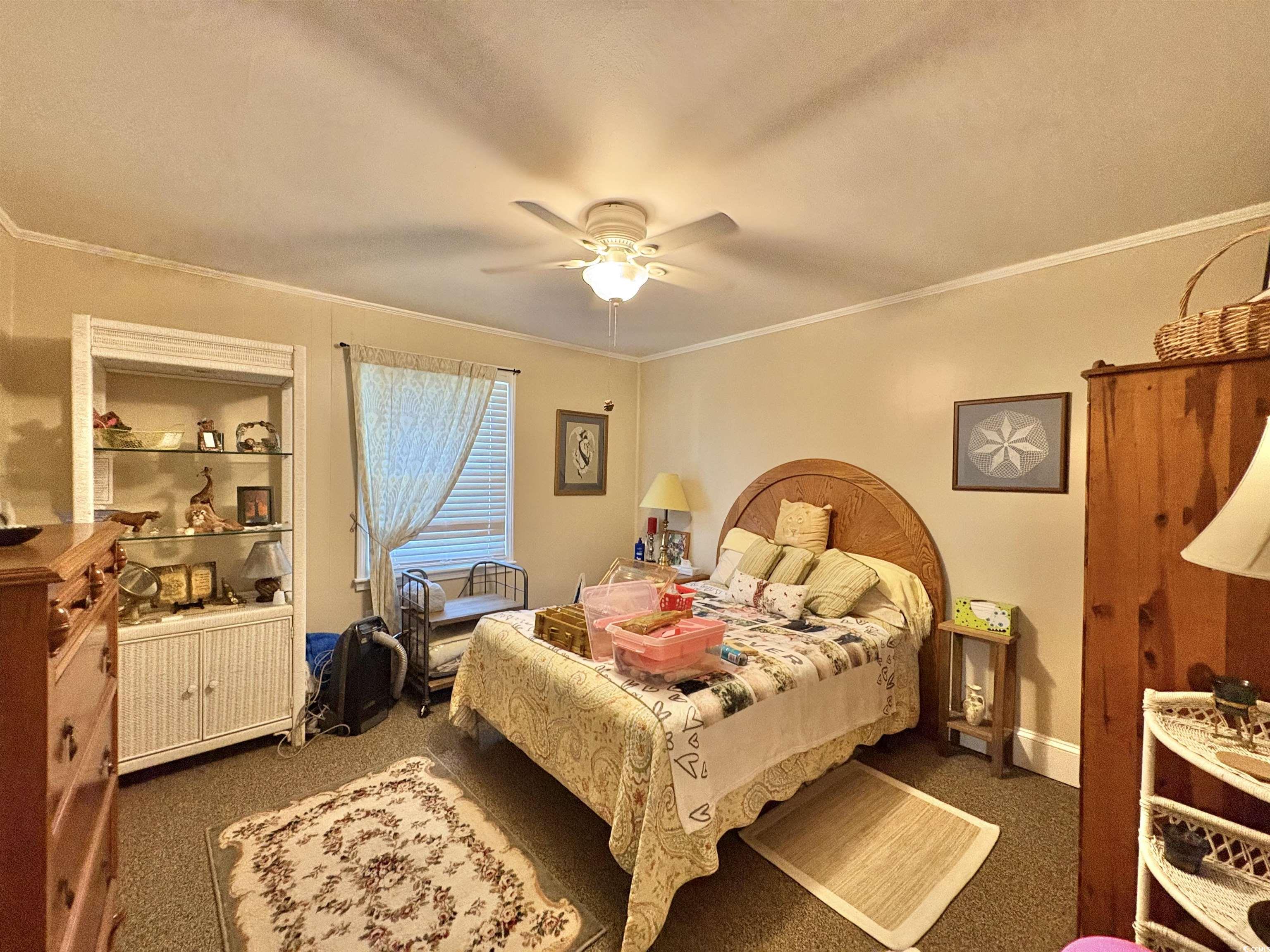 520-526 Boundary Avenue Murrells Inlet, SC 29576 - Photo 20 of 38 Carpeted bedroom with crown molding and a ceiling fan