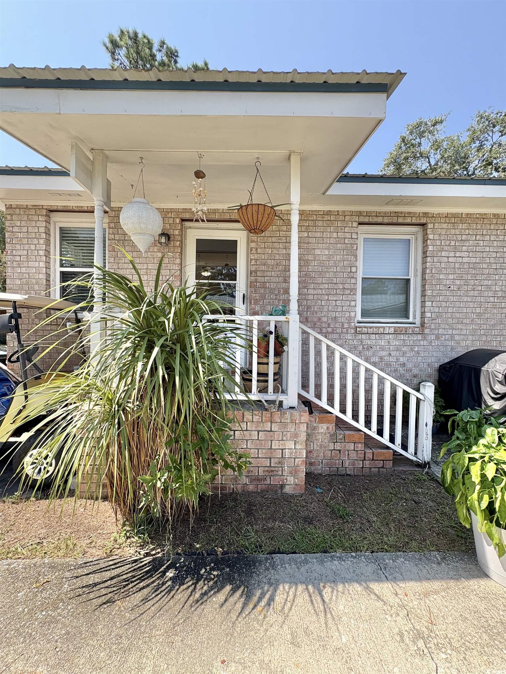 520-526 Boundary Avenue Murrells Inlet, SC 29576 - Photo 2 of 38 Doorway to property with brick siding