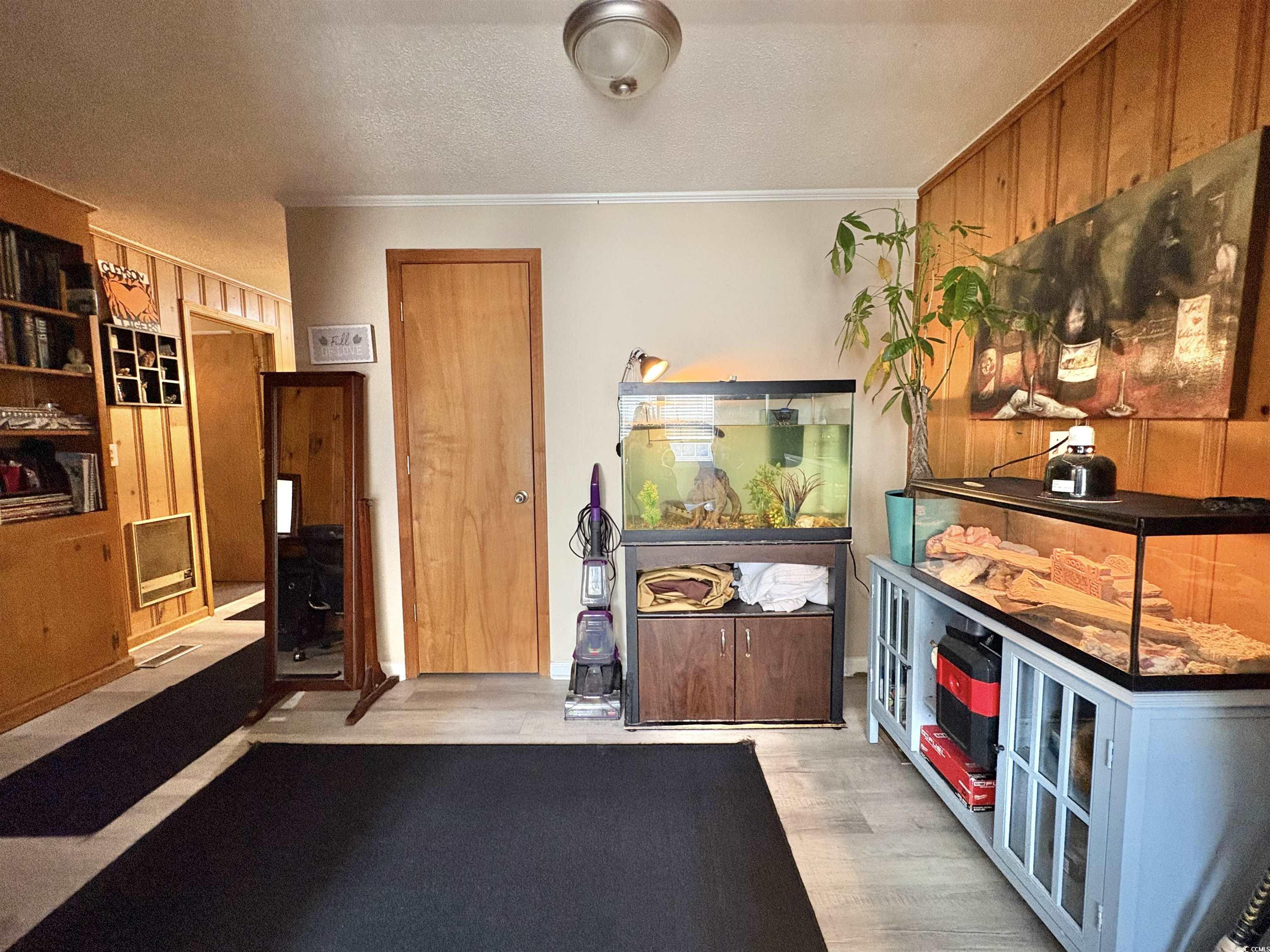 520-526 Boundary Avenue Murrells Inlet, SC 29576 - Photo 23 of 38 Miscellaneous room featuring light wood-style flooring, a textured ceiling, and crown molding