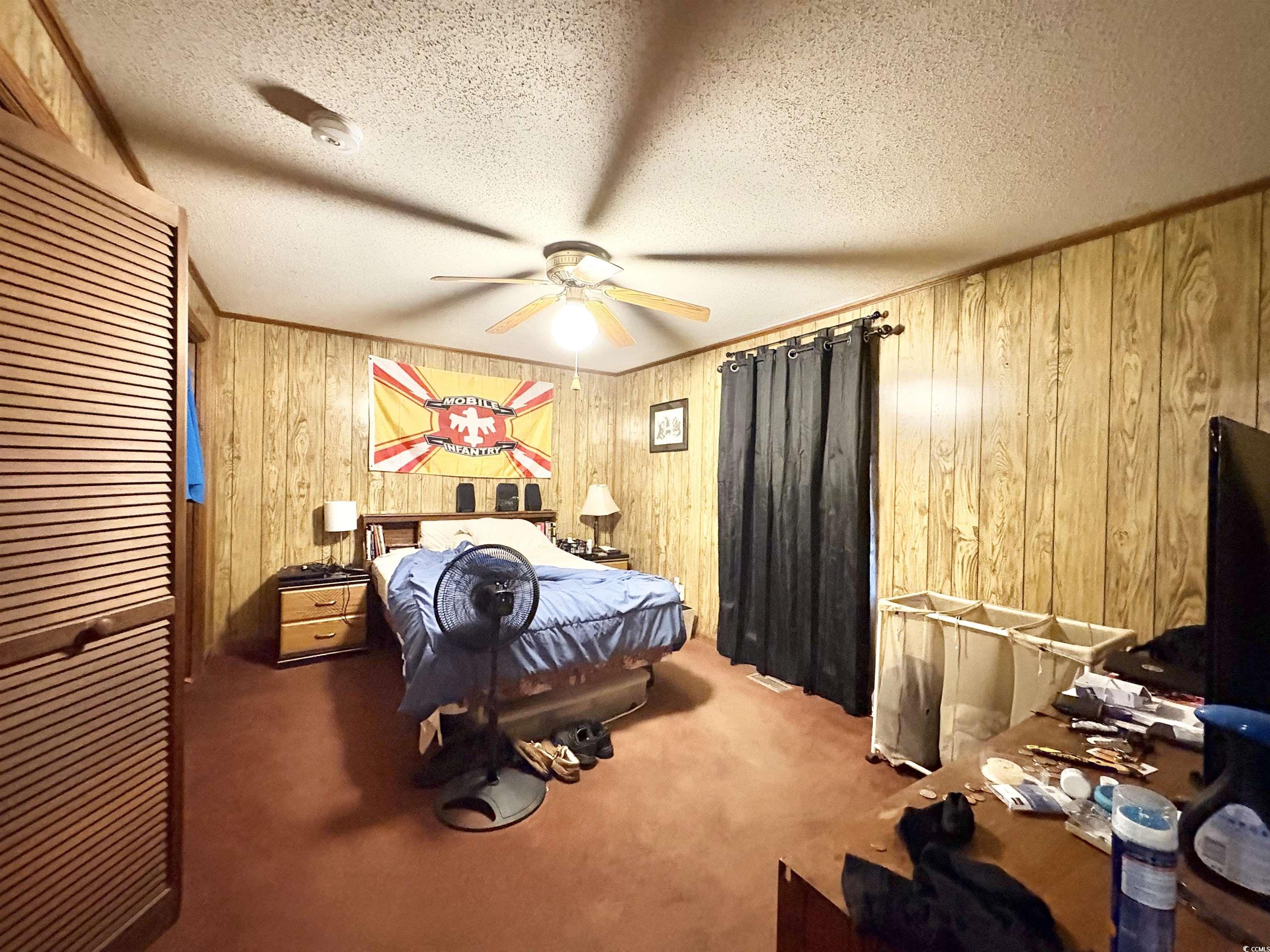 520-526 Boundary Avenue Murrells Inlet, SC 29576 - Photo 34 of 38 Bedroom with carpet floors, wood walls, and a textured ceiling