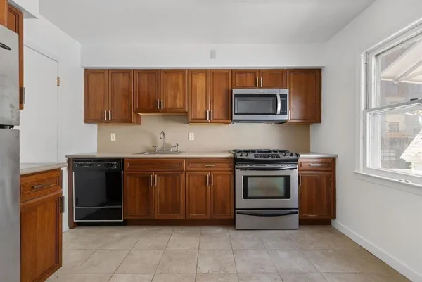 a kitchen with granite countertop a stove and a microwave