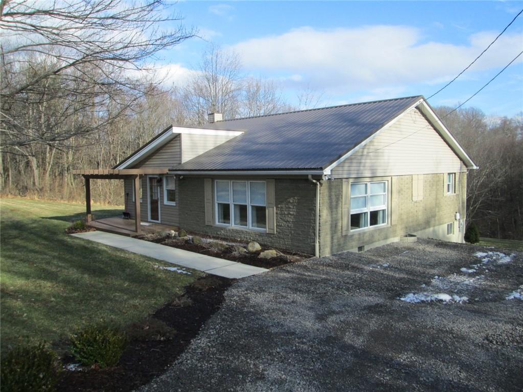 1651 Freeport Road Kittanning, PA 16201 - Photo 1 of 11 a front view of a house with a garden