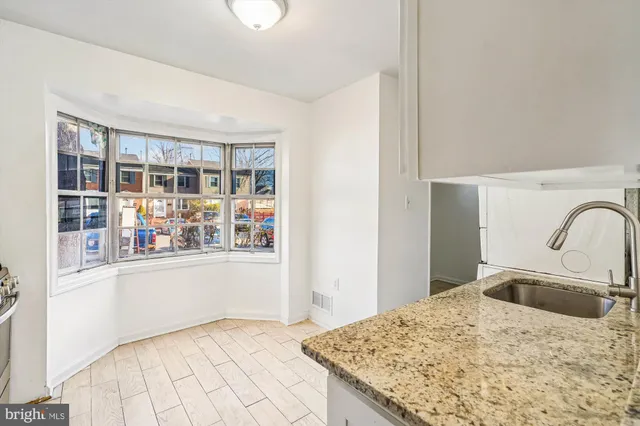 a kitchen with a stove a sink and a refrigerator