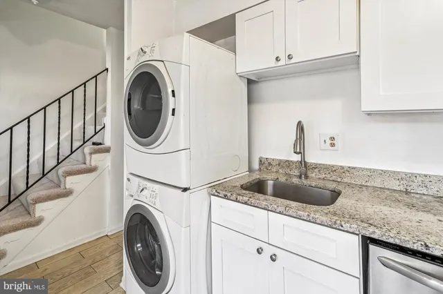 a kitchen with sink a washer and dryer