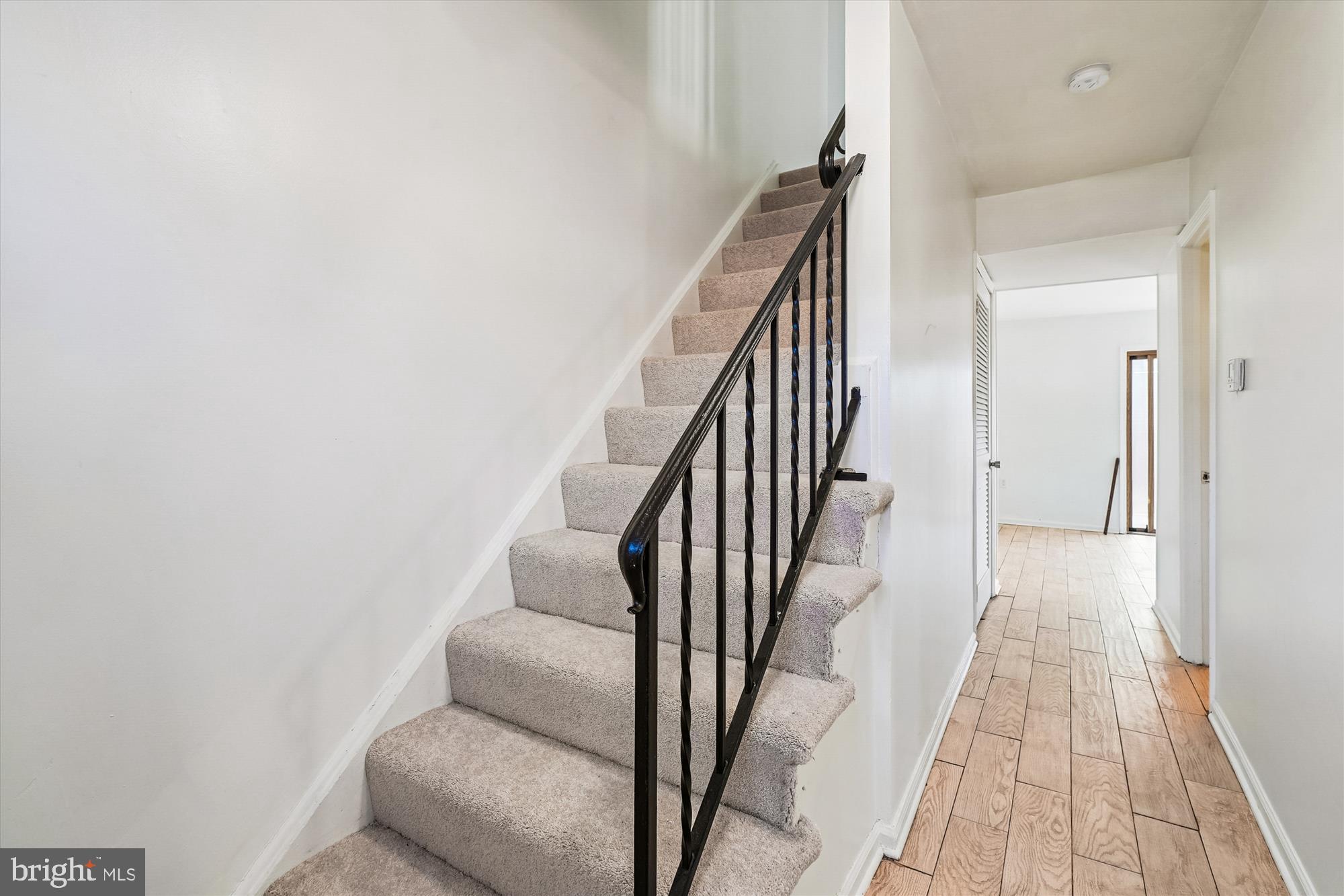 8347 Irongate Way Manassas, VA 20109 - Photo 3 of 42 a view of a hallway with wooden floor and staircase