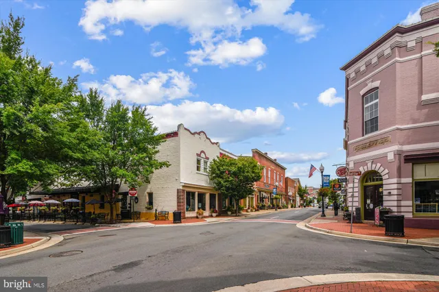 a city street lined with buildings and trees