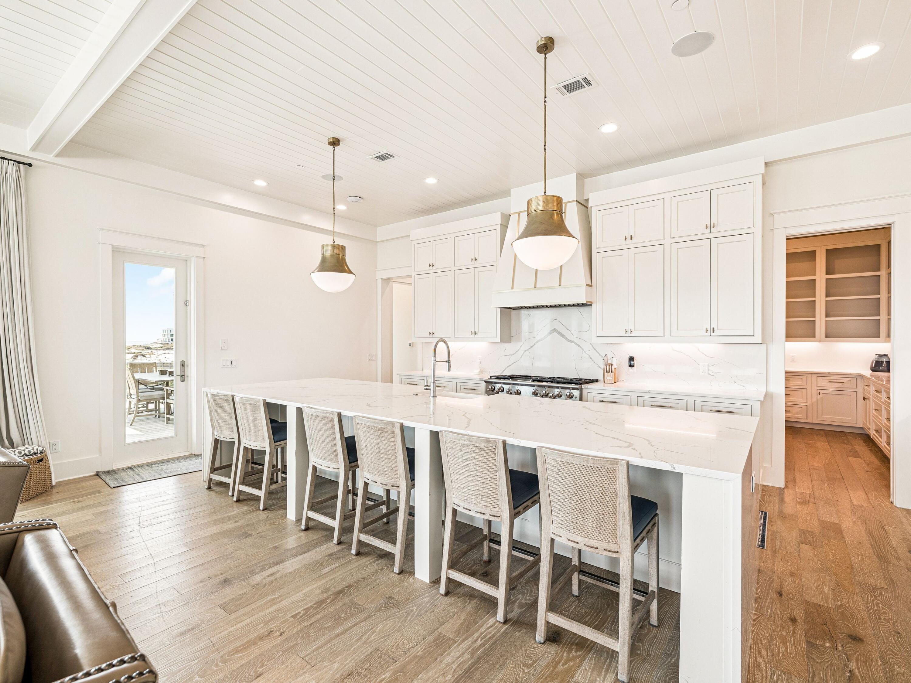 91 Emerald Cove Lane North Inlet Beach, FL 32461 - Photo 20 of 53 a kitchen with a dining table chairs sink and cabinets