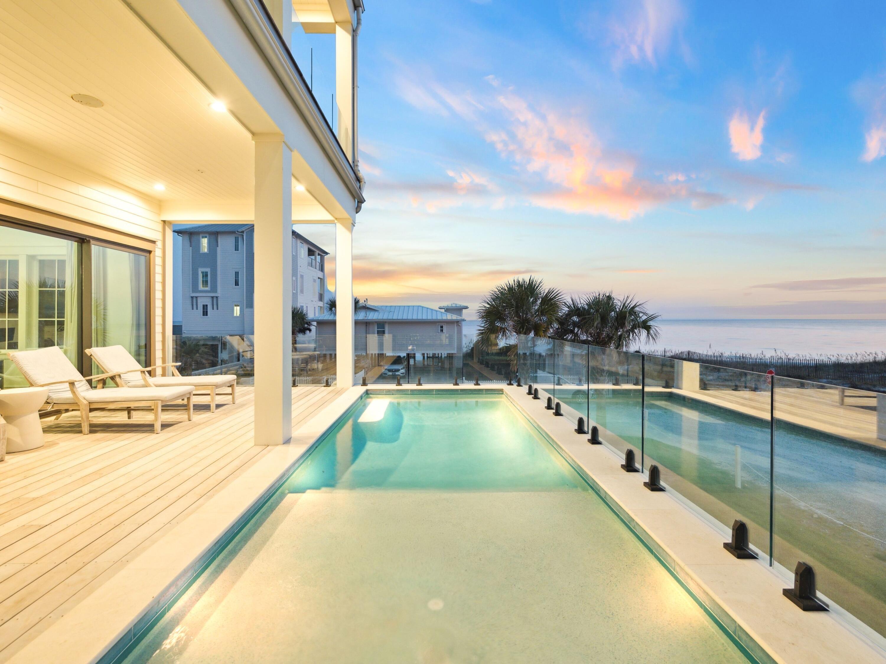 91 Emerald Cove Lane North Inlet Beach, FL 32461 - Photo 27 of 53 a view of a swimming pool with a lounge chair and floor to ceiling window