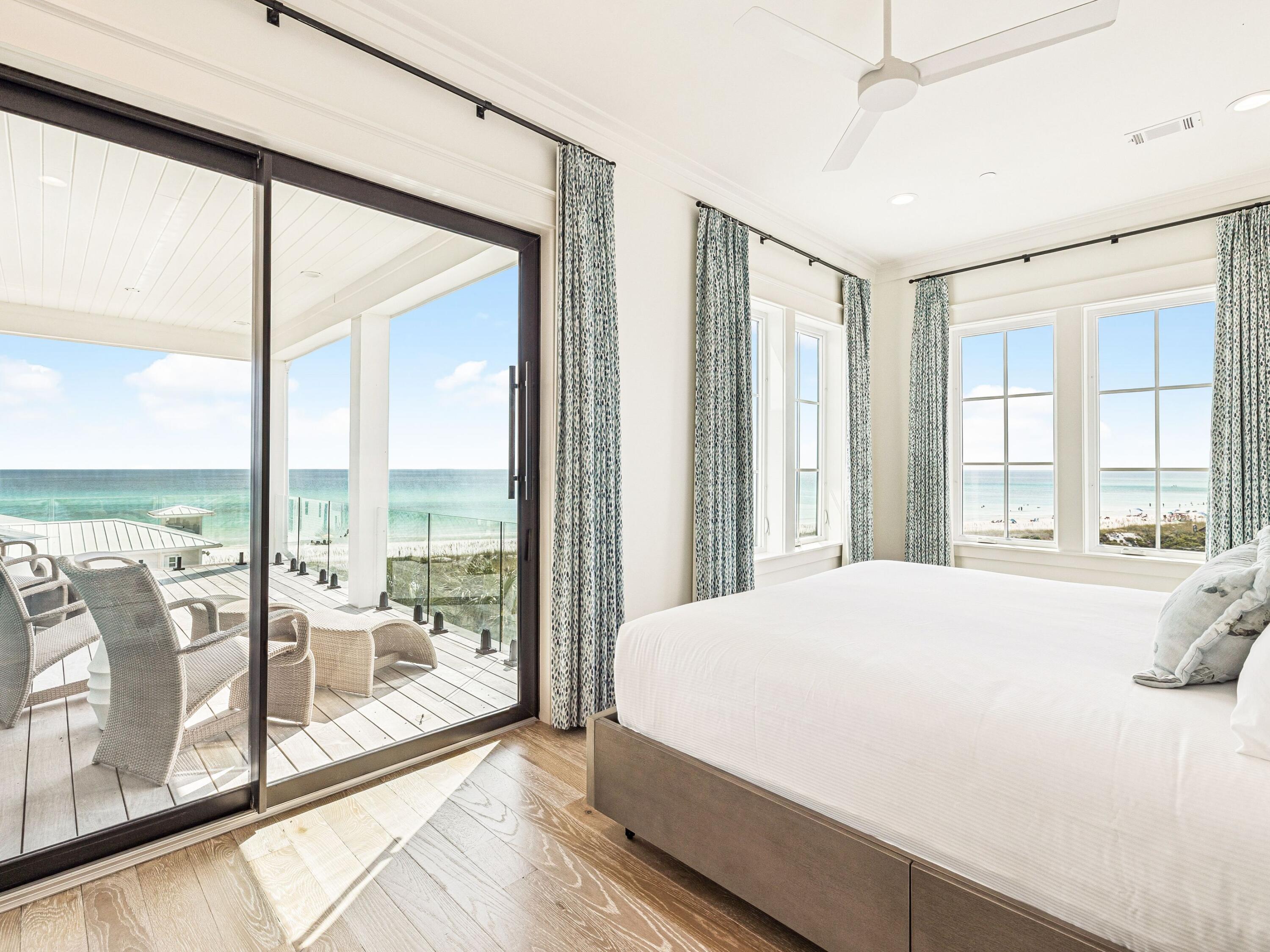 91 Emerald Cove Lane North Inlet Beach, FL 32461 - Photo 38 of 53 a bedroom with a large bed and a large window with the view of balcony