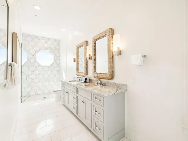 a living room with furniture and floor to ceiling windows