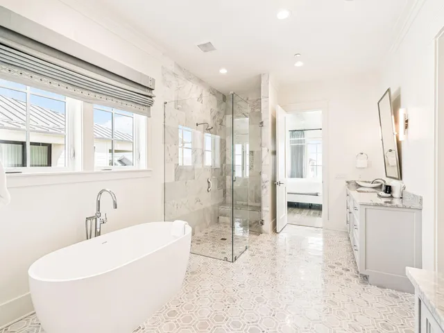 a bedroom with furniture and large windows