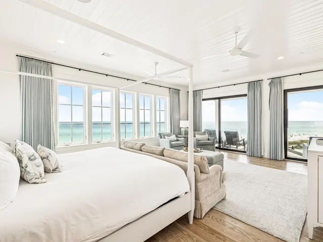 a spacious bedroom with a large bed and a large window