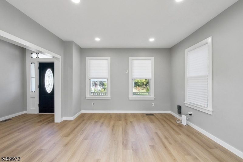 119 Wall Street Belvidere, NJ 07823 - Photo 6 of 25 an empty room with wooden floor and windows