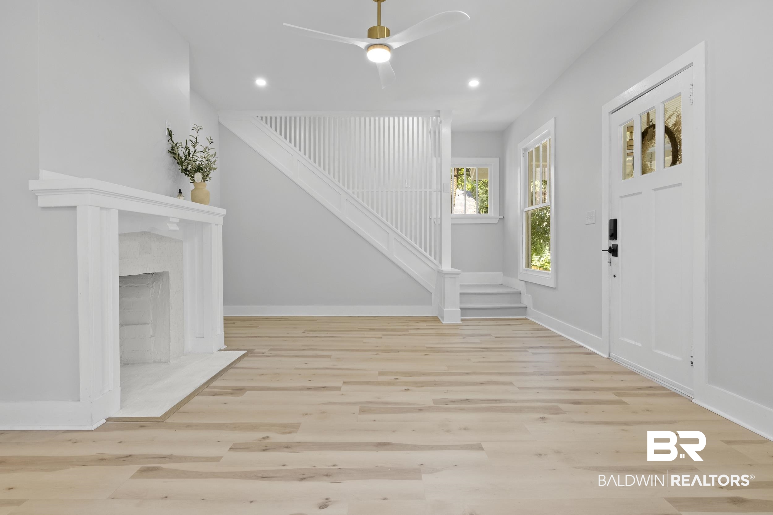 315 Park Avenue Mobile, AL 36607 - Photo 8 of 27 Entrance foyer with ceiling fan, light wood-type flooring, and a high end fireplace