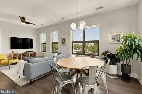 a view of a dining room with furniture window and wooden floor