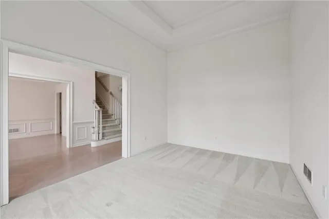 a view of empty room with a fireplace and fan