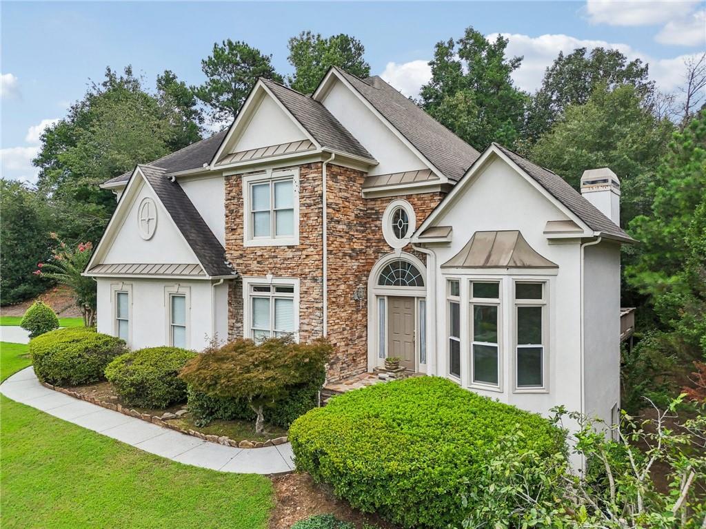 3540 Hickory Branch Trail Suwanee, GA 30024 - Photo 3 of 69 a view of a white house next to a yard with large trees