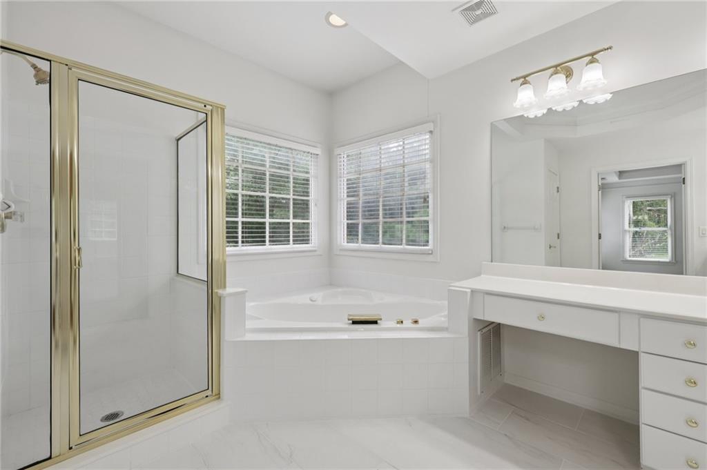 3540 Hickory Branch Trail Suwanee, GA 30024 - Photo 40 of 69 a bathroom with a tub sink and mirror