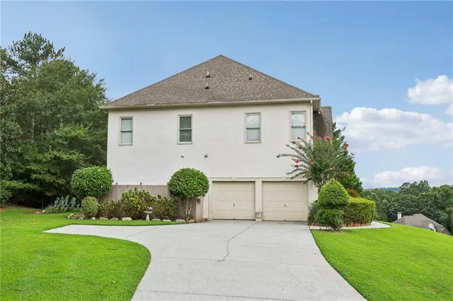 a front view of house with a yard and trees